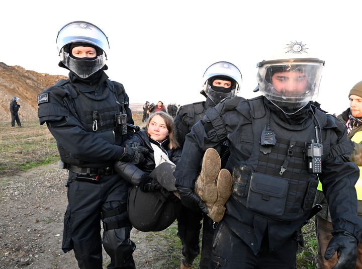 Officers carry climate activist Greta Thunberg away from a mine at Lützerath, Germany, on Tuesday.