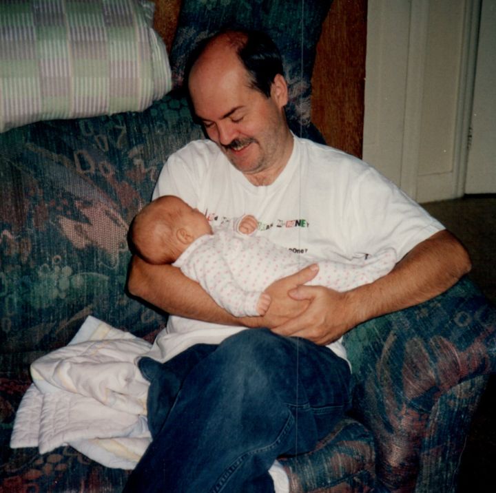 The author being held by her father.