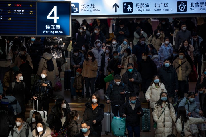 Travelers walk along a concourse at Beijing West Railway Station in Beijing, on Jan. 18, 2023.