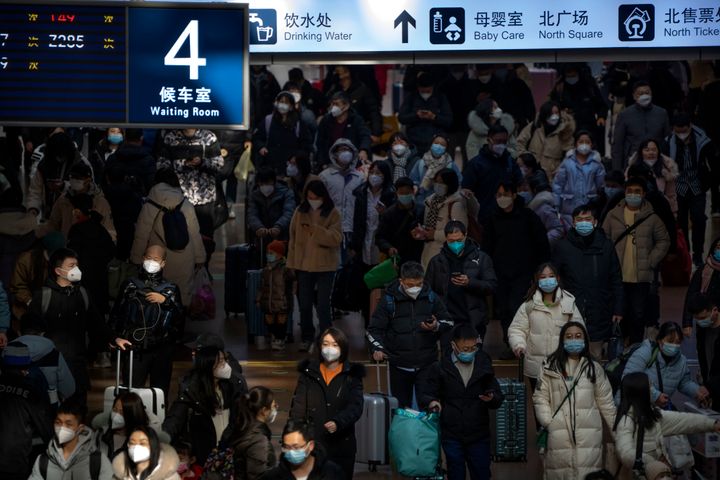 Travelers walk along a concourse at Beijing West Railway Station in Beijing, on Jan. 18, 2023. 