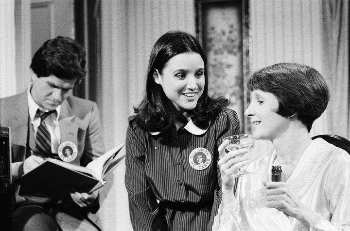 Julia Louis-Dreyfus (center) performs a skit with Tim Kazurinsky and Mary Gross on a 1982 episode of 
