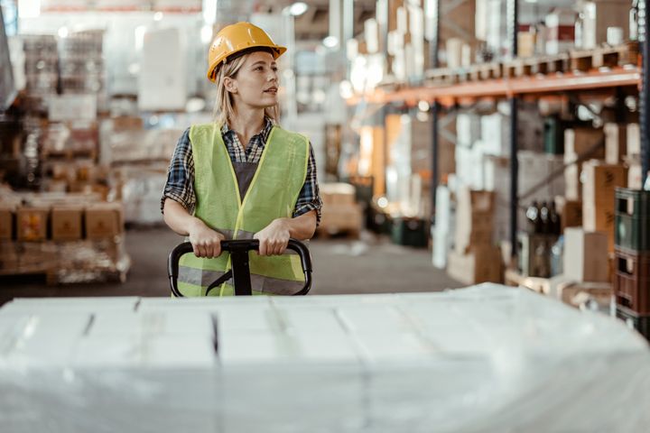 Female manual worker working in warehouse