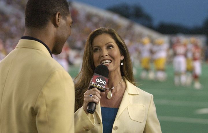 "Monday Night Football" sideline reporter Lisa Guerrero interviews Pro Football Hall of Famer Marcus Allen during the Hall of Fame game between the Green Bay Packers and the Kansas City Chiefs at Fawcett Stadium on Aug. 4, 2003, in Canton, Ohio.