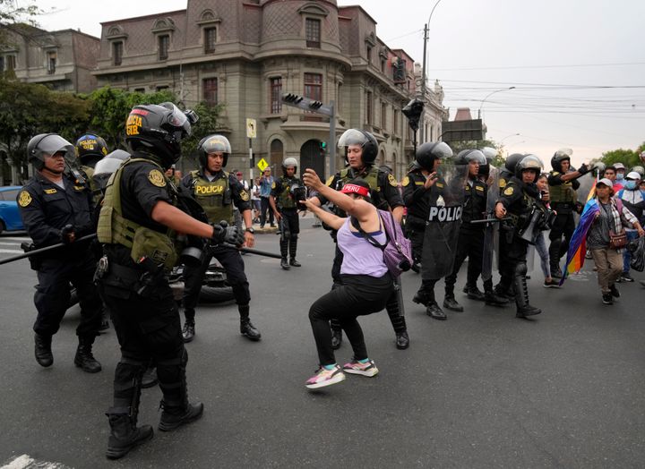 An anti-government protester who traveled to the capital from across the country to march against Peruvian President Dina Boluarte, is detained by the police in Lima, Peru, on Jan. 18, 2023.