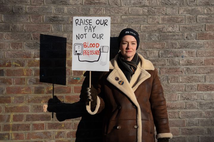A nurse poses with her placard during a strike by members of the Royal College of Nursing Union on January 19, 2023.