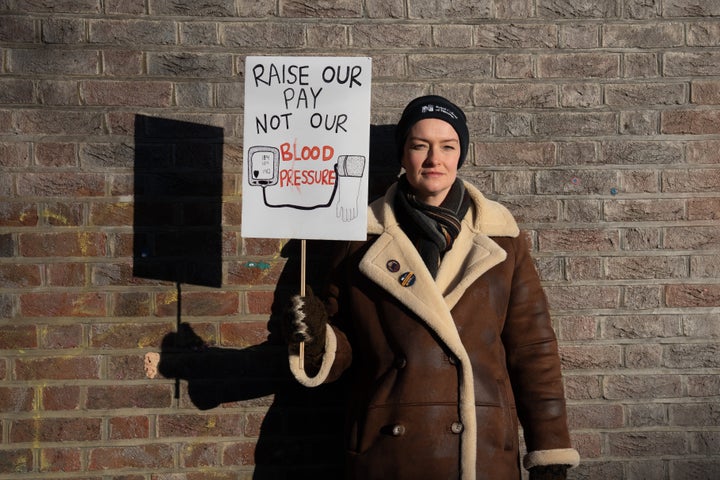 A nurse poses with her placard during a strike by members of the Royal College of Nursing Union on January 19, 2023.