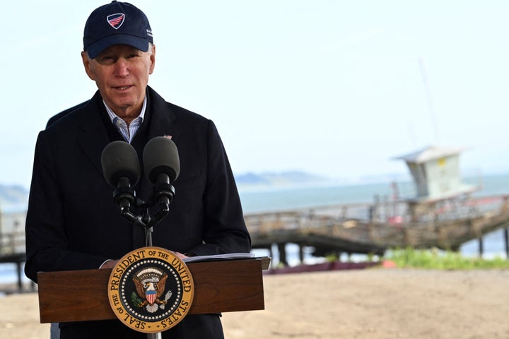 A pier that collapsed in a storm is seen behind Biden as he speaks in Aptos, California, on January 19, 2023. He cited severe weather as causing the country's climate change.
