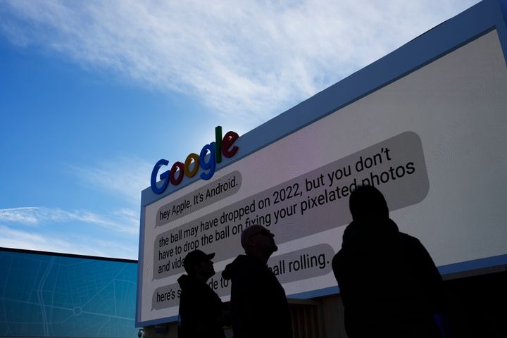 Workers help set up the Google booth at the Las Vegas Convention Center before the start of the CES tech show, on Jan. 2, 2023, in Las Vegas.