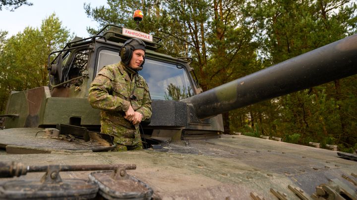 A Slovakian soldier gets out of a Bundeswehr Leopard II driving school tank