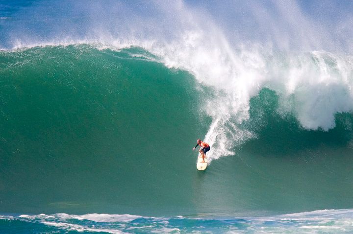 Florida surfer Kelly Slater drops down the face of a big wave at The Eddie in 2009. 