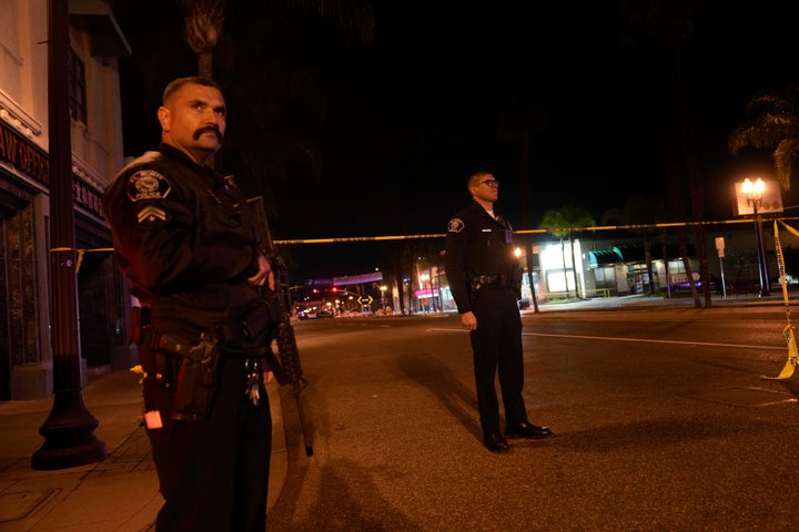 Two police officers stand guard near a scene where a shooting took place in Monterey Park, Calif., Sunday, Jan. 22, 2023. (AP Photo/Jae C. Hong)