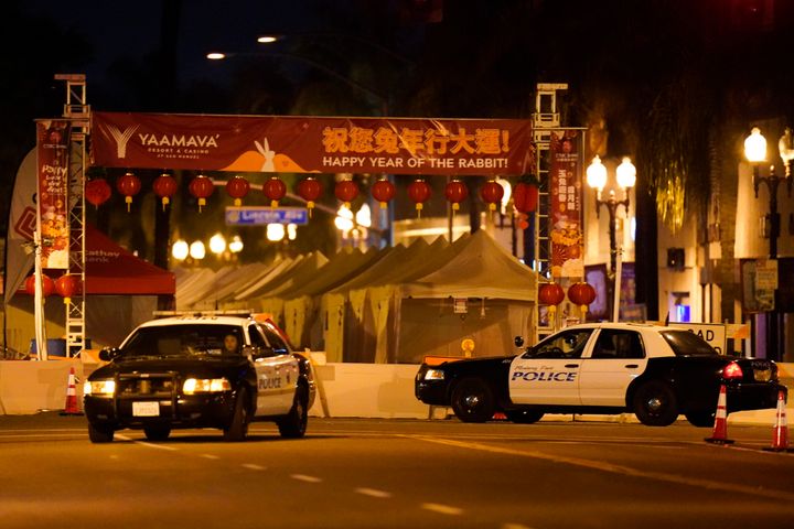 Two police vehicles are seen near a building where a shooting occurred in Monterey Park, Calif., Sunday, Jan. 22, 2023. (AP Photo/Jae C. Hong)