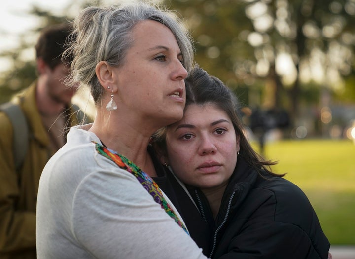 Beth Paz (left) and Jolie Slater comfort each other at a gathering held to honor the victims killed in a mass shooting Saturday at a ballroom dance studio in Monterey Park, Calif., Sunday.