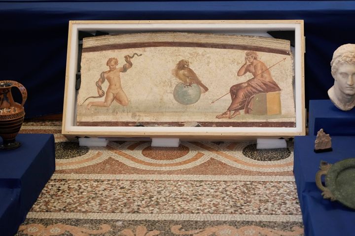 A Pompeiian-style fresco from Herculaneum titled "Young Hercules and the snake," is seen on display among other archaeological artifacts stolen from Italy and sold in the U.S. by international art traffickers.