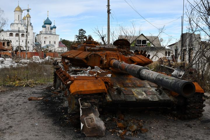 A destroyed Russian tank stands by the road in front of an orthodox temple in the liberated town of Sviatohirsk. 