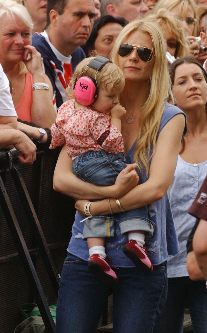Gwyneth Paltrow holds her daughter Apple as they join the audience at Live 8 London in Hyde Park July 2, 2005 in London.
