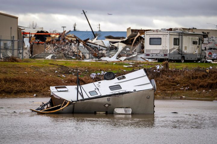 A camping trailer sits in a retention pond where a tornado was reported to pass along Mickey Gilley Blvd., near Fairmont Parkway, on Jan. 24, 2023, in Pasadena, Texas. 