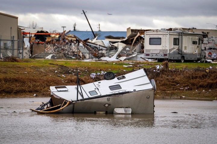 A camping trailer sits in a retention pond where a tornado was reported to pass along Mickey Gilley Blvd., near Fairmont Parkway, on Jan. 24, 2023, in Pasadena, Texas.