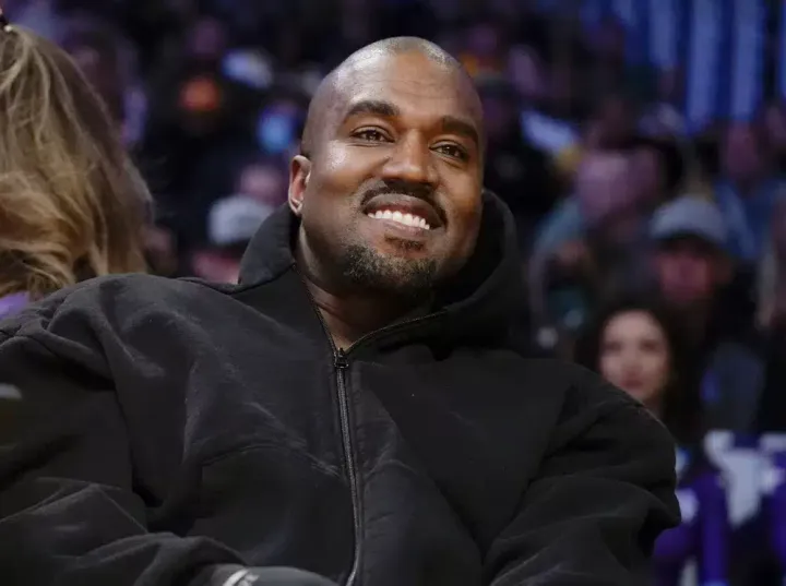 Kanye West, known as Ye, watches the first half of an NBA basketball game between the Washington Wizards and the Los Angeles Lakers March 11 in Los Angeles.