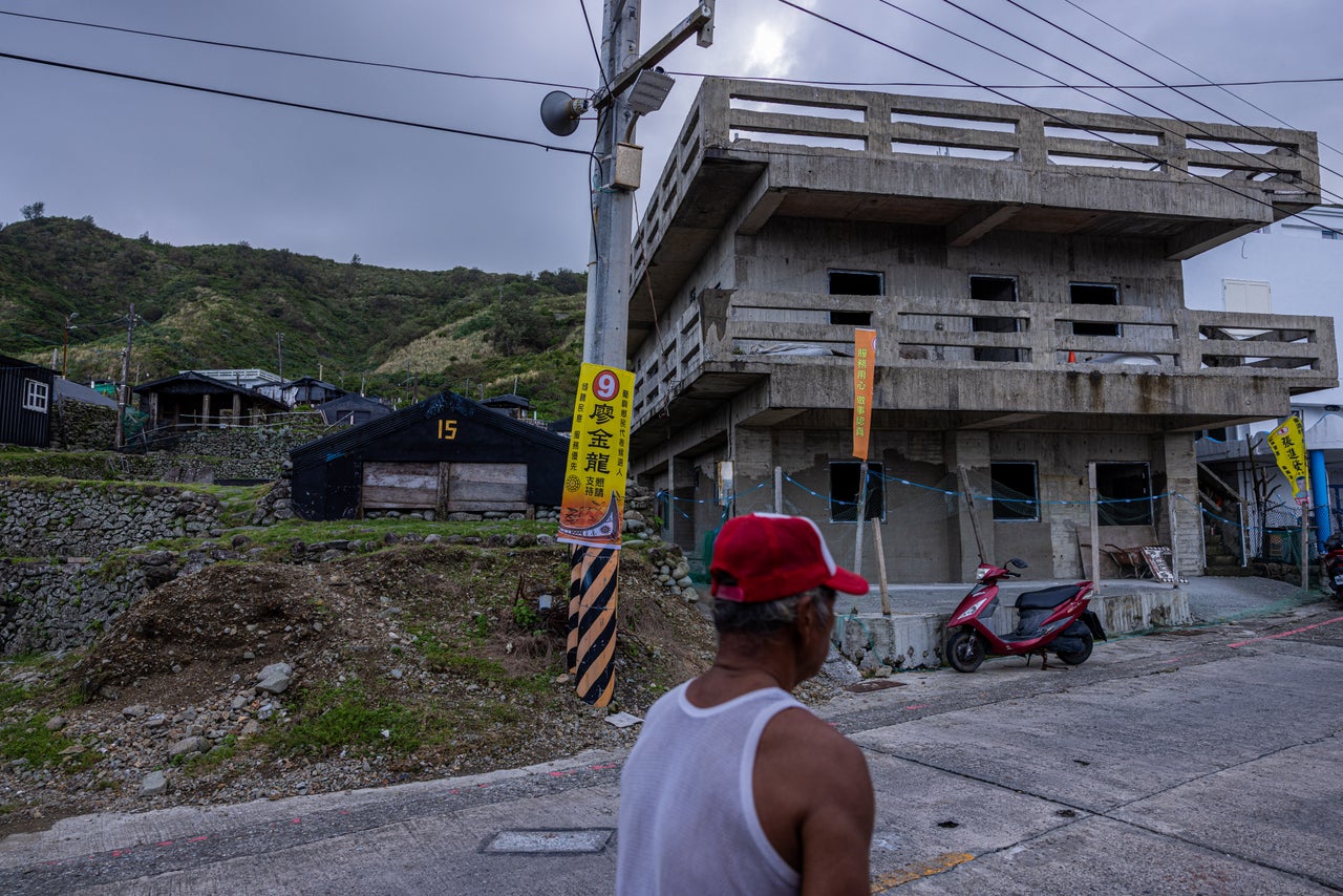 A site of preserved semi-basement houses is seen next to a modern construction site on Orchid Island.