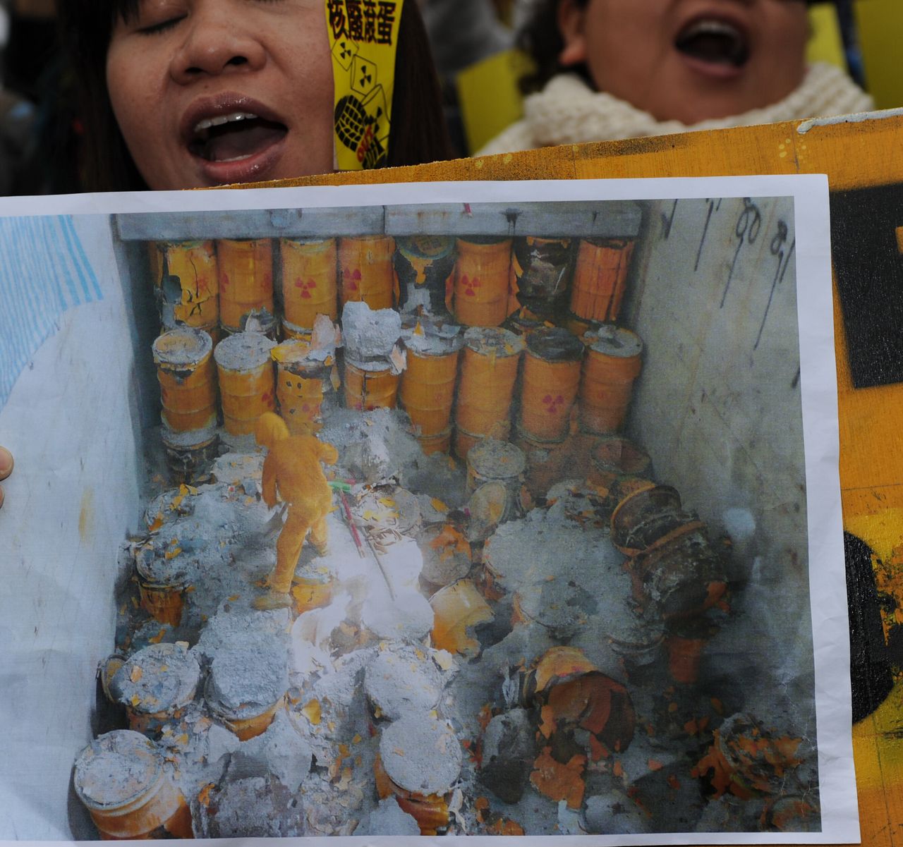 Demonstrators display a picture of nuclear waste stockpiled on Orchid Island during an anti-nuclear-power demonstration in Taipei on March 11, 2012. Thousands of people chanted anti-nuclear slogans and march through downtown Taipei demanding that the government shut down its three nuclear power plants in operation and halt construction of a half-completed one.