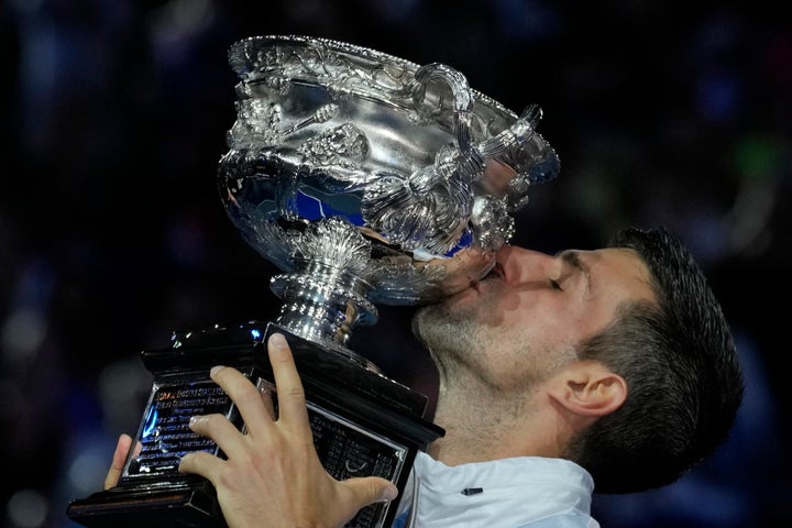 Novak Djokovic of Serbia kisses the Norman Brookes Challenge Cup after defeating Stefanos Tsitsipas of Greece in the men's singles final at the Australian Open tennis championship in Melbourne, Australia, Sunday, Jan. 29, 2023. (AP Photo/Aaron Favila)