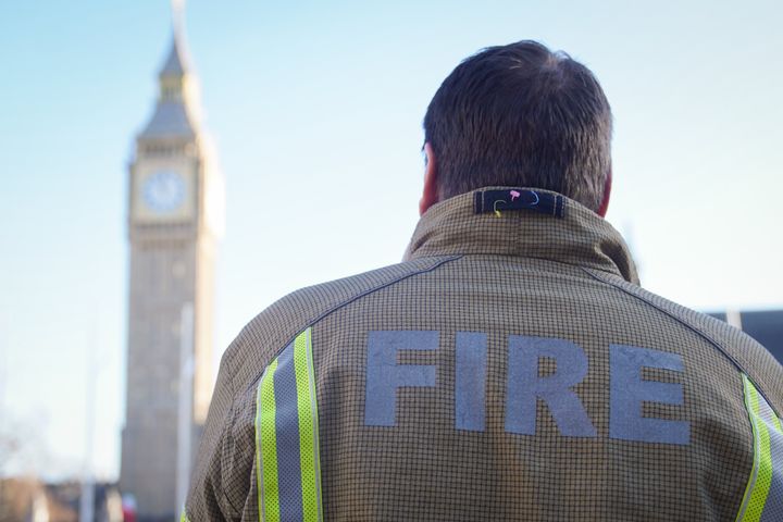 A firefighter in Parliament Square, central London, ahead of a rally to mark the start of a ballot for strikes in a dispute over pay. 
