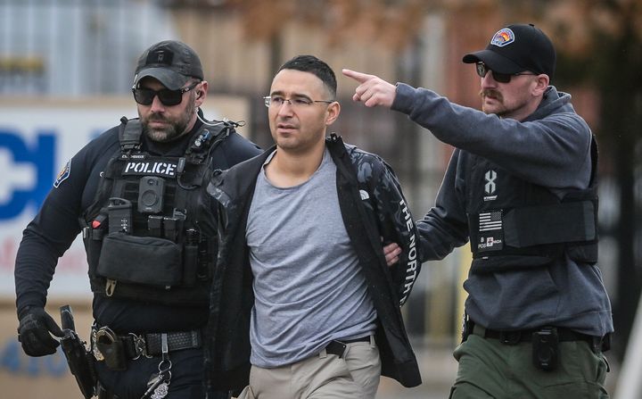 Solomon Peña, center, a Republican candidate for New Mexico House District 14, is taken into custody by Albuquerque Police officers on Jan. 16.