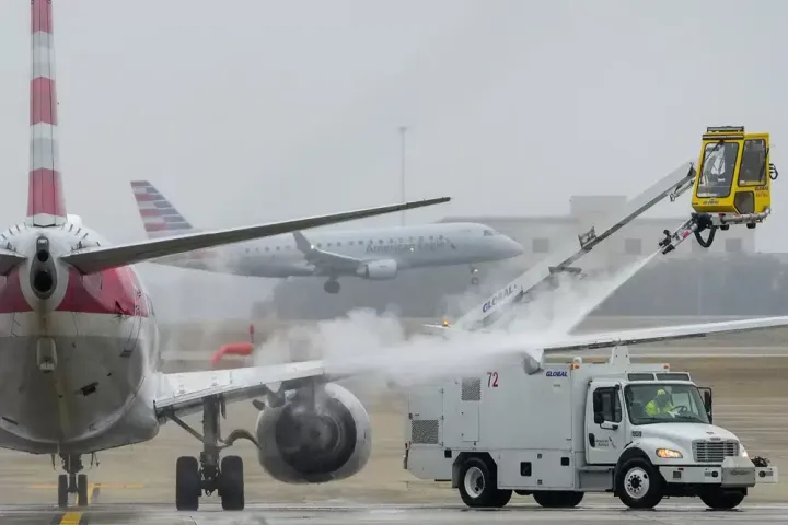 An American Airlines aircraft undergoes deicing procedures on Jan. 30 at Dallas/Fort Worth International Airport in Texas.