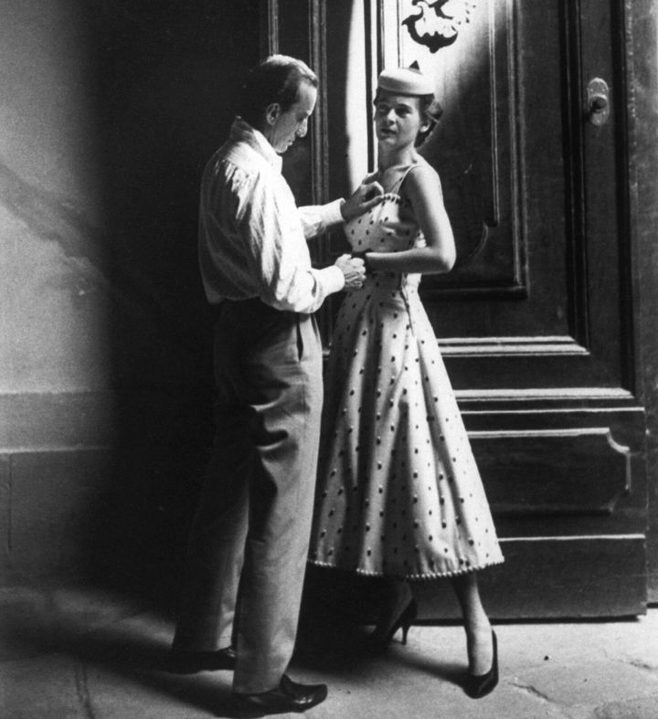 Italian fashion and fabric designer Emilio Pucci works with one of his fit models circa 1954.