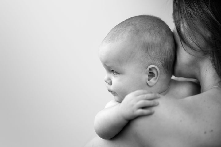 A stock image of a mother holding her baby.