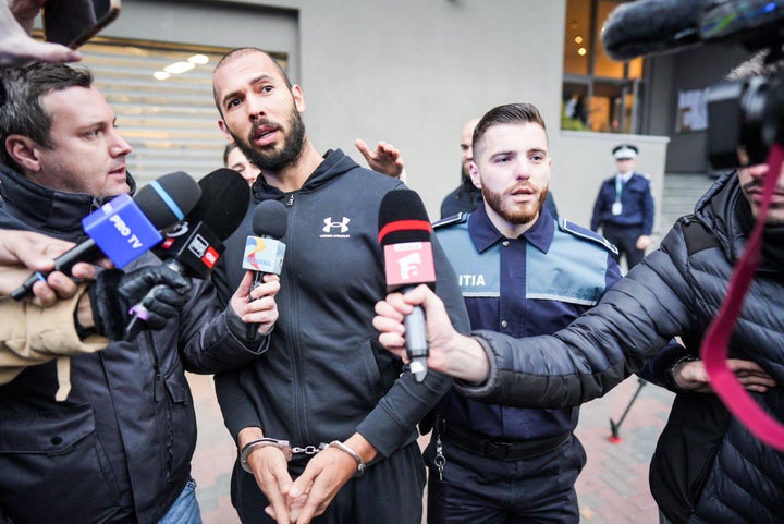 British-US former professional kickboxer and controversial influencer Andrew Tate talks to media as he leaves Romania's anti-organized crime and terrorism directorate (DIICOT), after a digital investigation of devices, where his presence was required, in Bucharest, Romania on January 25, 2023. (Photo by MIHAI BARBU / AFP) (Photo by MIHAI BARBU/AFP via Getty Images)