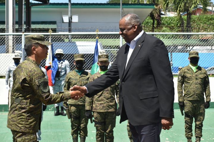In this handout photo provided by the Command Public Information Office, Western Mindanao Command, U.S. Defense Secretary Lloyd Austin III, right, greets Western Mindanao Commander Lt. Gen. Roy Galido as he visits Camp Don Basilio Navarro in Zamboanga province, southern Philippines on Wednesday Feb. 1, 2023. Austin is in the Philippines for talks about deploying U.S. forces and weapons in more Philippine military camps to ramp up deterrence against China's increasingly aggressive actions toward Taiwan and in the disputed South China Sea. (Command Public Information Office, Western Mindanao Command via AP)