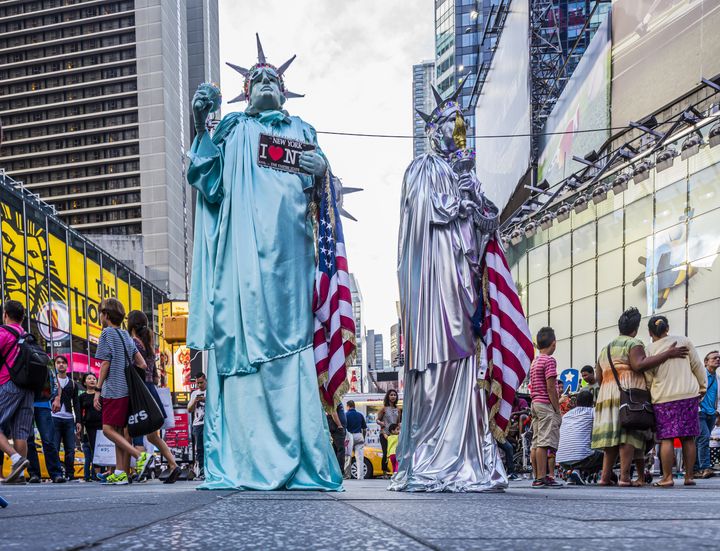 Street performers dressed as the Statue of Liberty in New York