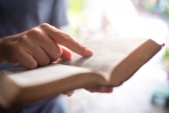 Woman reading bible.