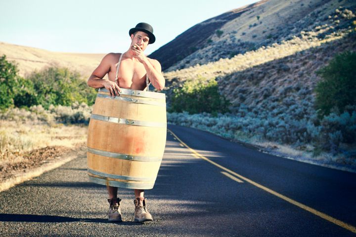 Bankruptcy or poverty concept. A man with nothing left but his whiskey barrel, boots and hat.