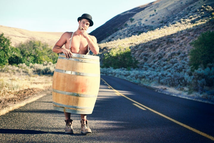 Bankruptcy or poverty concept. A man with nothing left but his whiskey barrel, boots and hat.