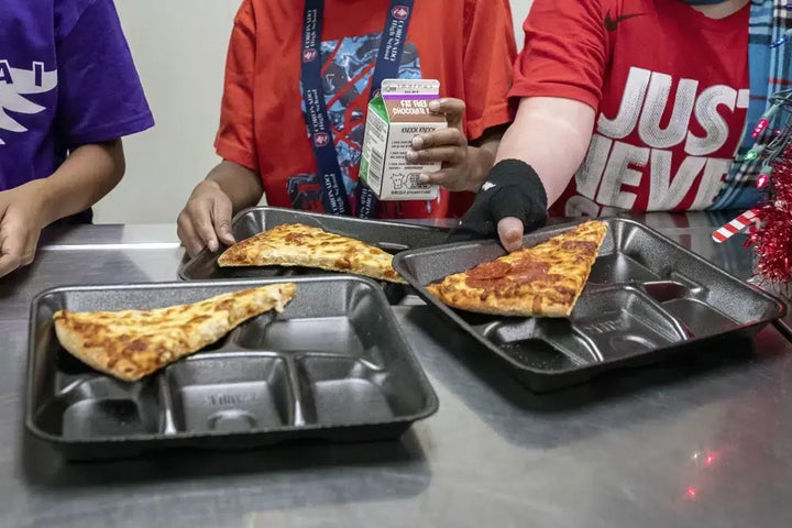 FILE - Second-grade students select their meals during lunch break in the cafeteria at an elementary school in Scottsdale, Ariz., on Dec. 12, 2022.