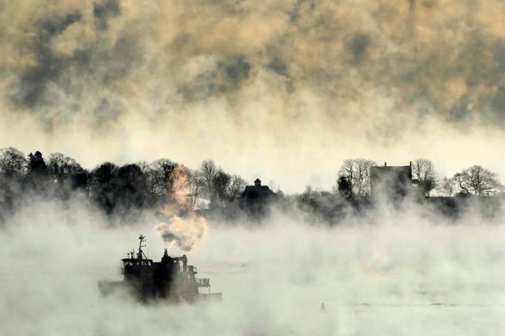 Arctic sea smoke rises from the the Atlantic Ocean as a passenger ferry passes House Island Saturday, Feb. 4, 2023, off the coast of Portland, Maine.