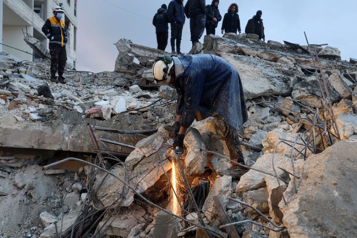 Members of the Syrian civil defence, known as the White Helmets, look for casualties under the rubble following an earthquake in the town of Zardana in the countryside of the northwestern Syrian Idlib province, early on Feb. 6, 2023.
