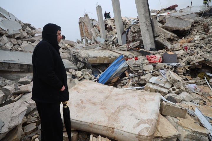 A man stands next to the rubble of a building following an earthquake in the town of Sarmada in the countryside of the northwestern Syrian Idlib province, early on Feb. 6, 2023.