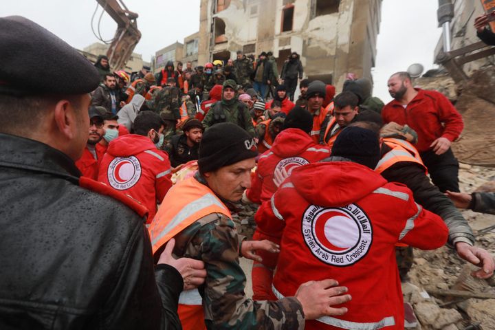 Syrian rescue teams search for victims and survivors at the rubble a collapsed building in the city of Aleppo following a deadly earthquake on Feb. 6, 2023.