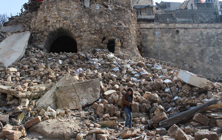 A boy stands on rubble in the aftermath of an earthquake near Aleppo's ancient citadel, in the old city of Aleppo, Syria February 7, 2023.