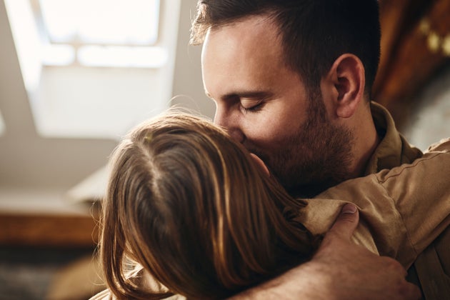 A stock image of a man and his daughter at home