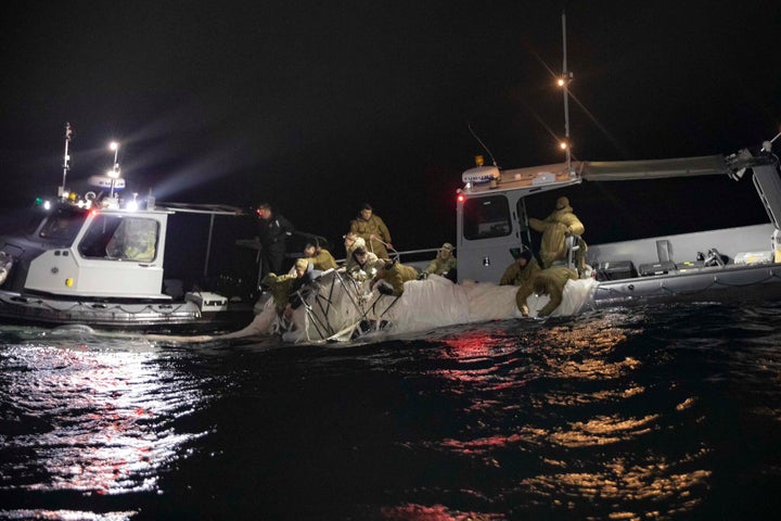 Sailors with the U.S. Navy recover parts of a suspected Chinese spy balloon.