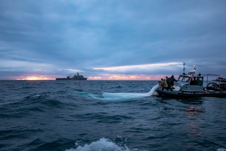 Sailors with the US Navy recover parts of a suspected Chinese spy balloon.