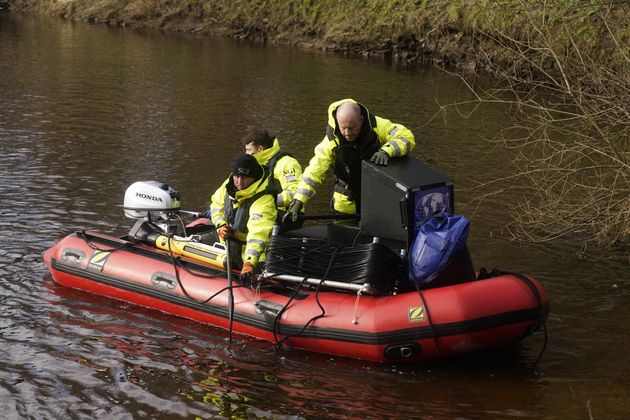 Workers from private underwater search and recovery company, Specialist Group International, on the river in St Michael's on Wyre, Lancashire.