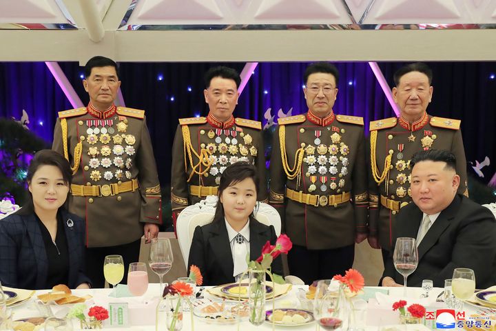 In this photo provided by the North Korean government, North Korean leader Kim Jong Un, right, with his wife Ri Sol Ju, left, and his daughter poses with military top officials for a photo at a feast to mark the 75th founding anniversary of the Korean People’s Army at an unspecified place in North Korea Tuesday, Feb. 7, 2023. Independent journalists were not given access to cover the event depicted in this image distributed by the North Korean government. The content of this image is as provided and cannot be independently verified. Korean language watermark on image as provided by source reads: "KCNA" which is the abbreviation for Korean Central News Agency. 
