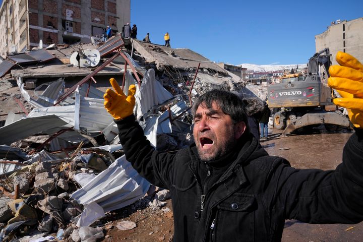 A man reacts, after rescue teams found his father dead under a collapsed building, in Kahramanmaras, southern Turkey, on Feb. 8, 2023. 