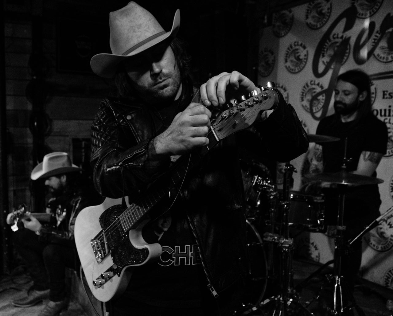 Gaultier changes strings on his guitar before a show at Gerstles in Louisville.